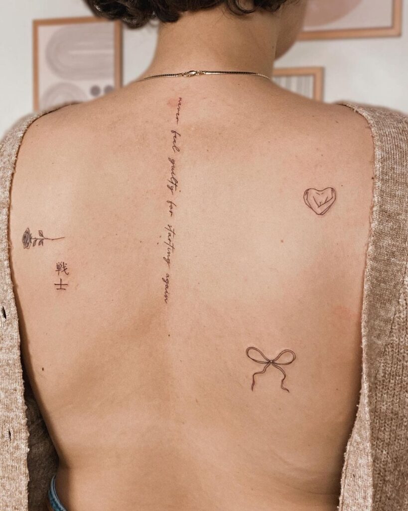 Mixed Symbolic Elements with "Never Feel Guilty" Tattoo Spine Tattoos for Women