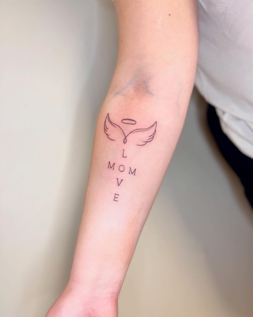 Angel Wings and Vertical ‘Mom Love’ Forearm Tattoo angel wings tattoo ideas tattoo