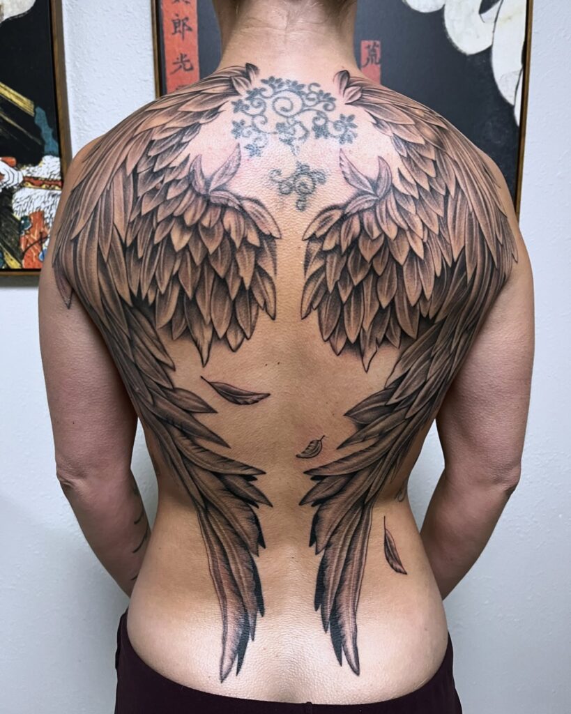 Elegant Full-Back Angel Wings with Falling Feathers Tattoo angel wings tattoo ideas on back tattoo