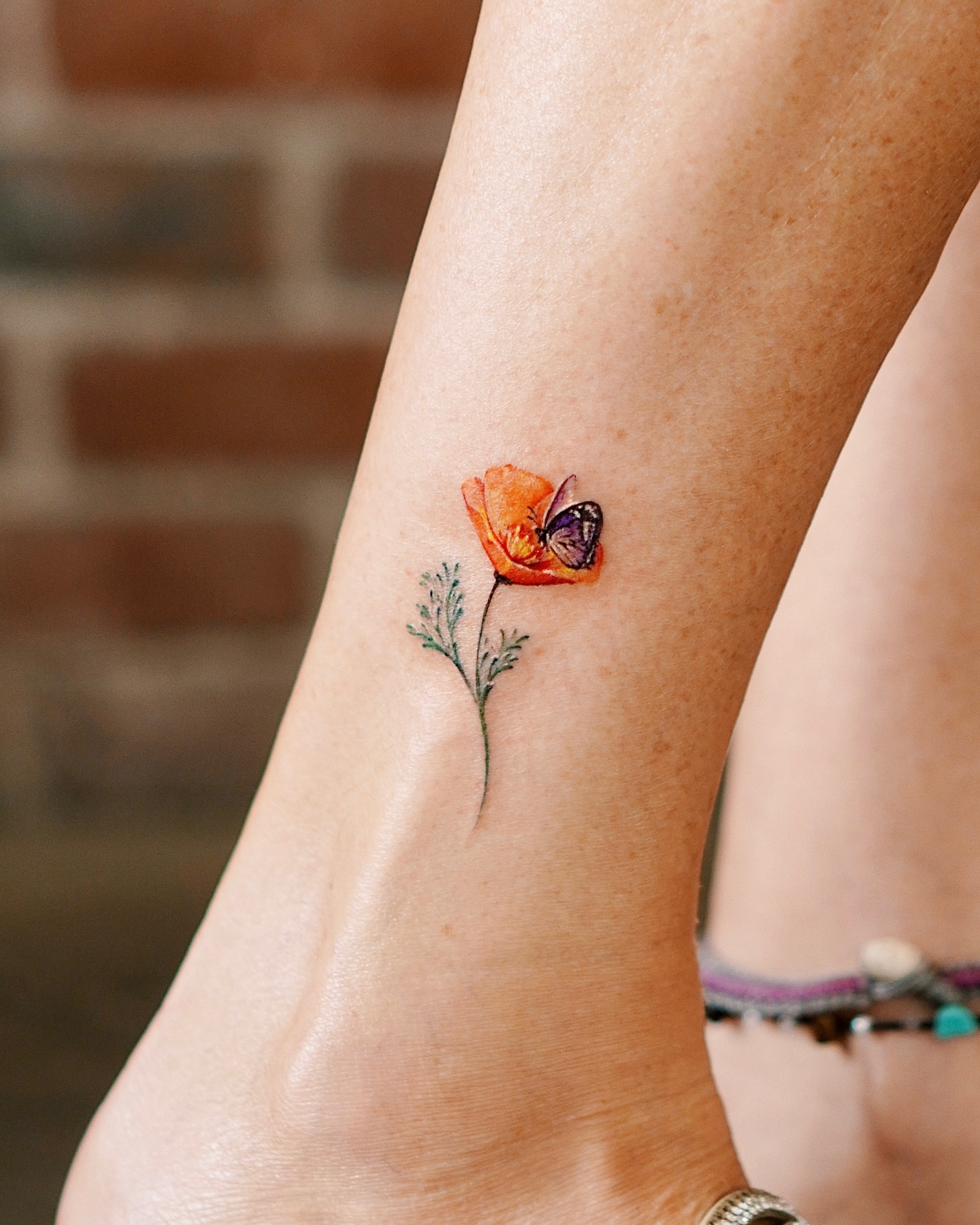 Butterfly On Poppy Flower Tattoo