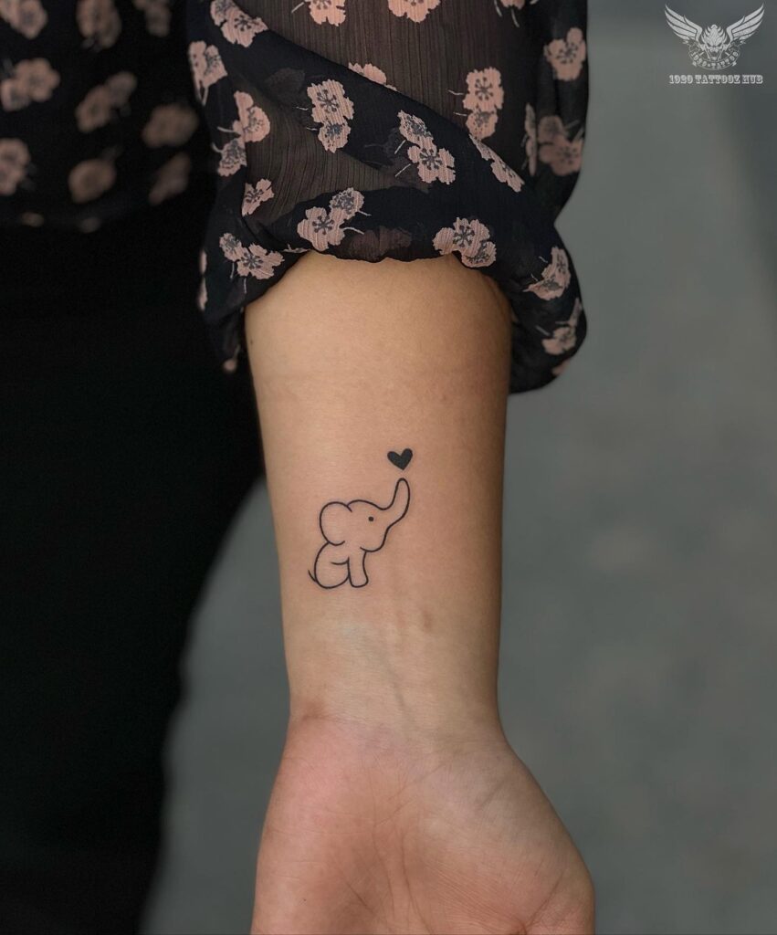Cute baby elephant tattoo with tiny heart