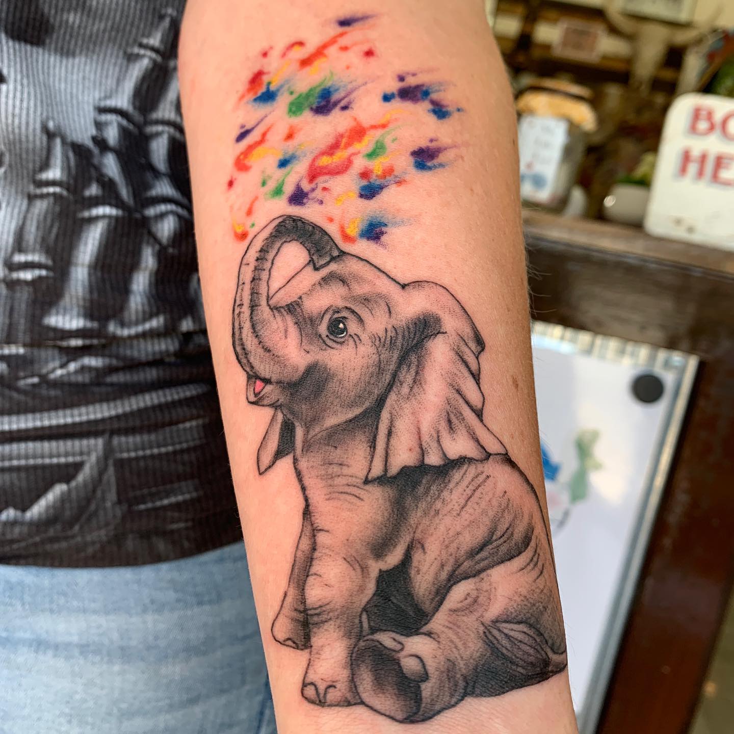 Baby Elephant With Rainbow Splash Tattoo baby elephant tattoo ideas tattoo