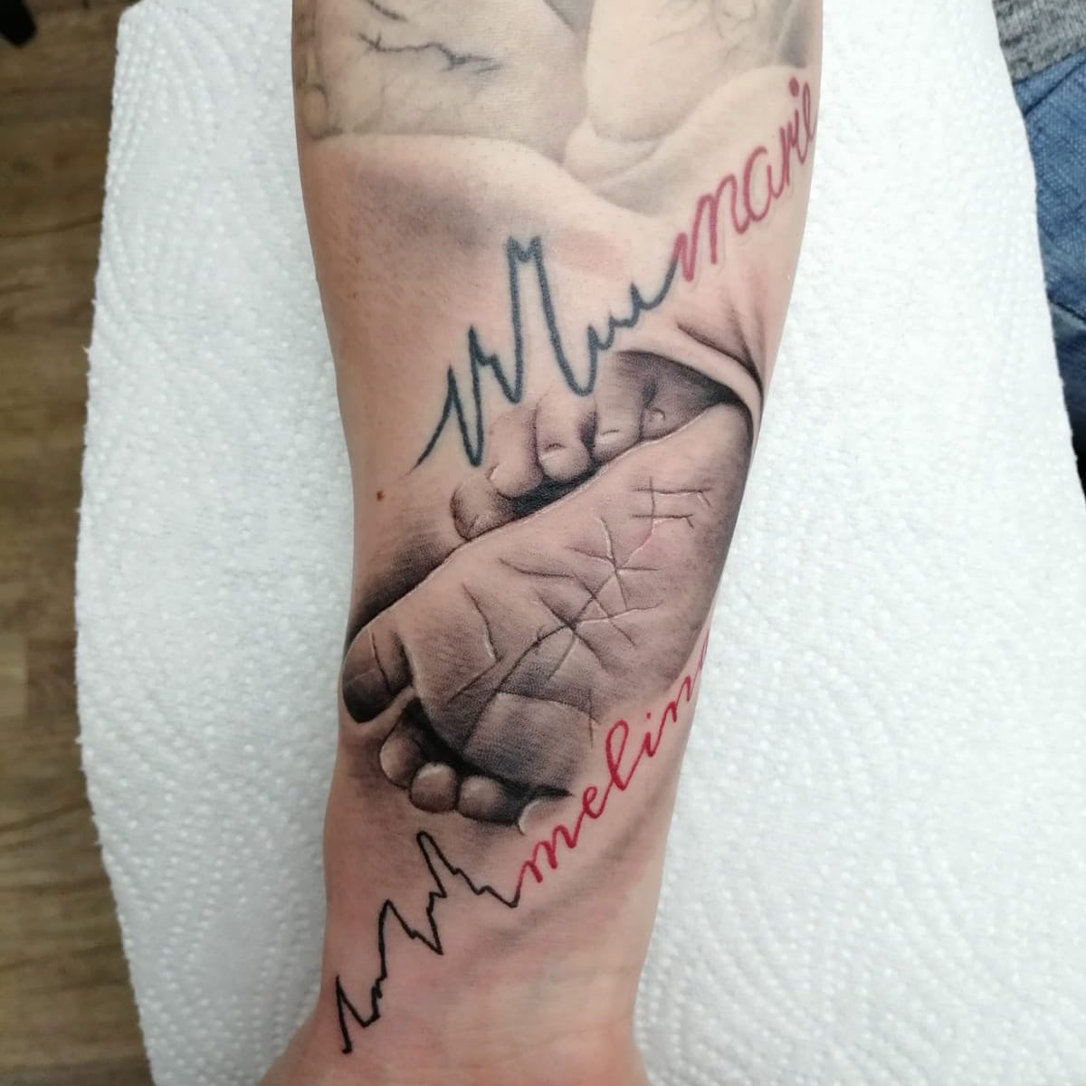 Baby Footprint in Protective Hands Tattoo baby feet tattoos ideas tattoo