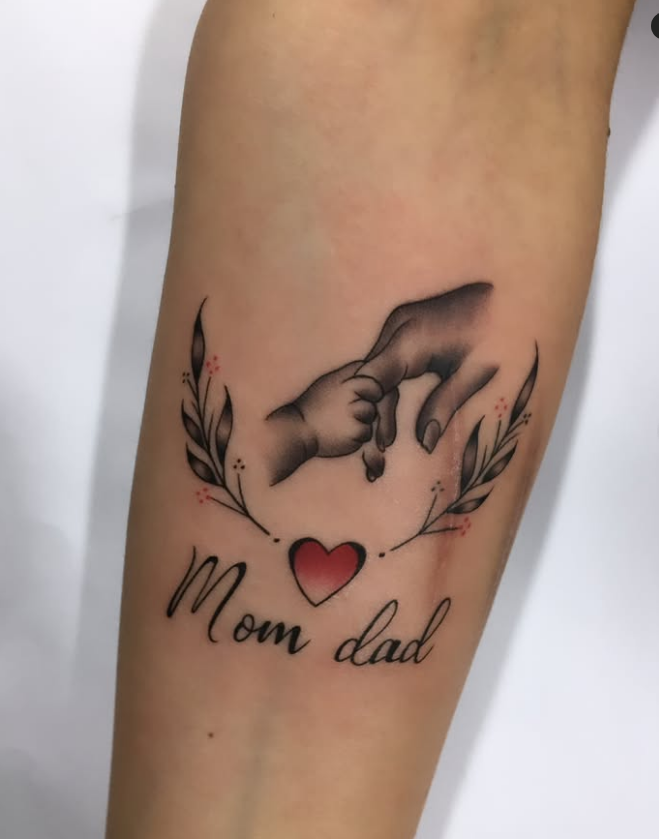 Baby Hand Holding Parents Tattoo with Heart and Leaves mom dad tattoos tattoo