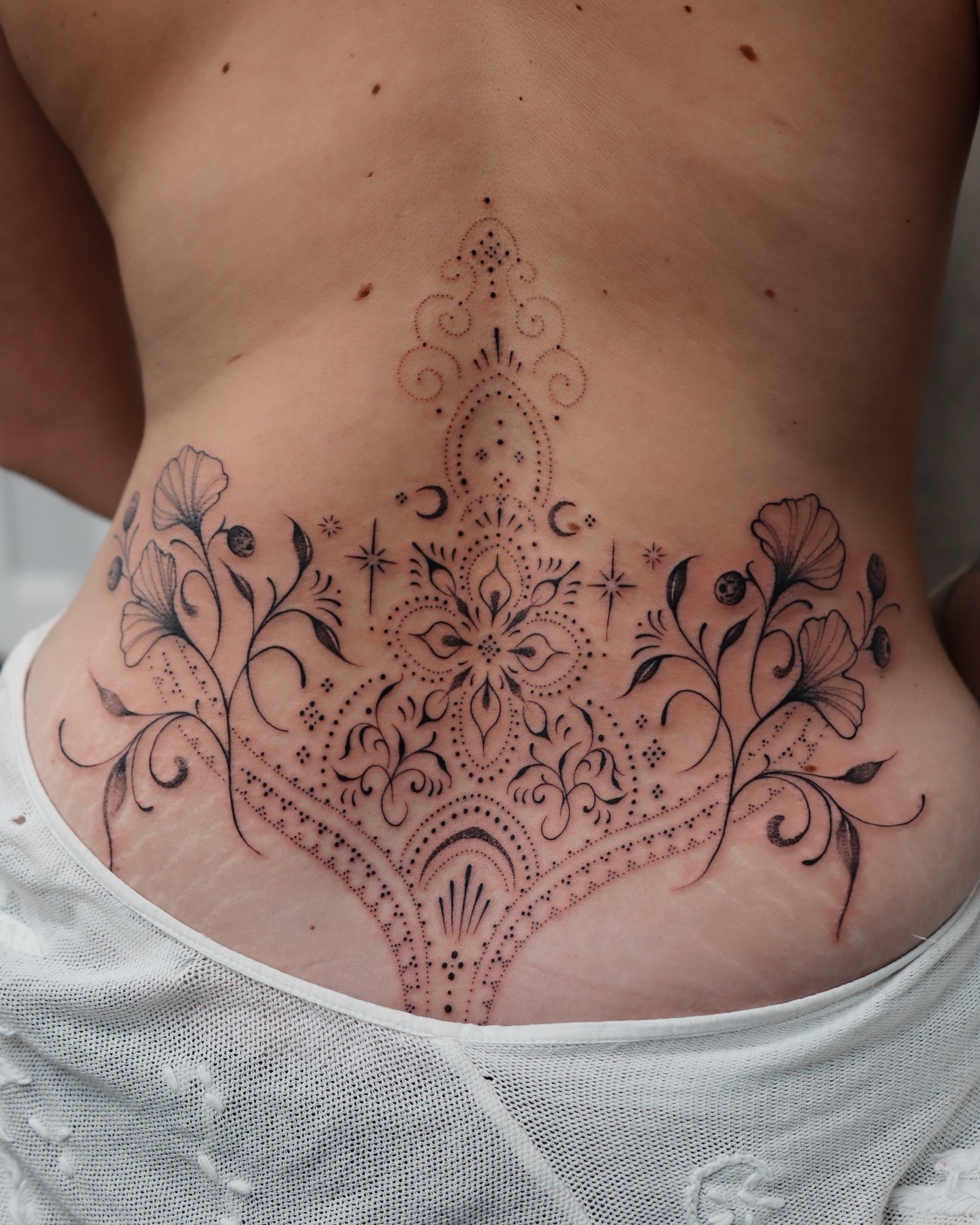 Ornamental Floral Lower Back Tattoo