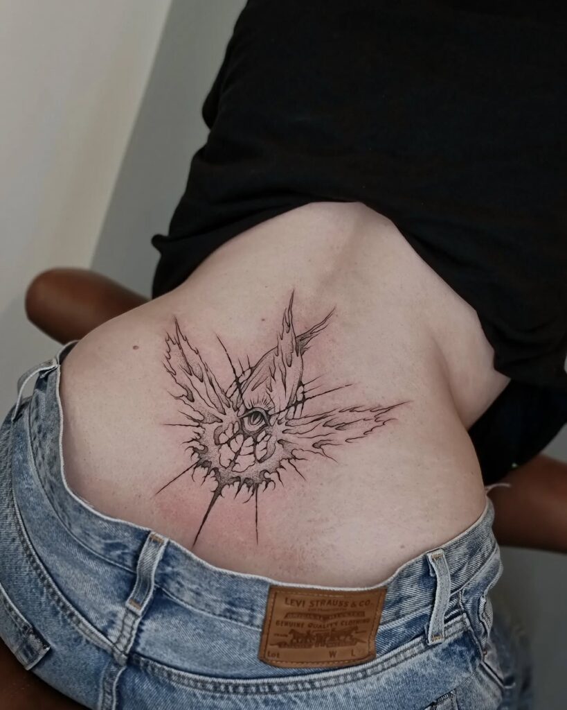 Sun And Ornamental Chains Lower Back Tattoo