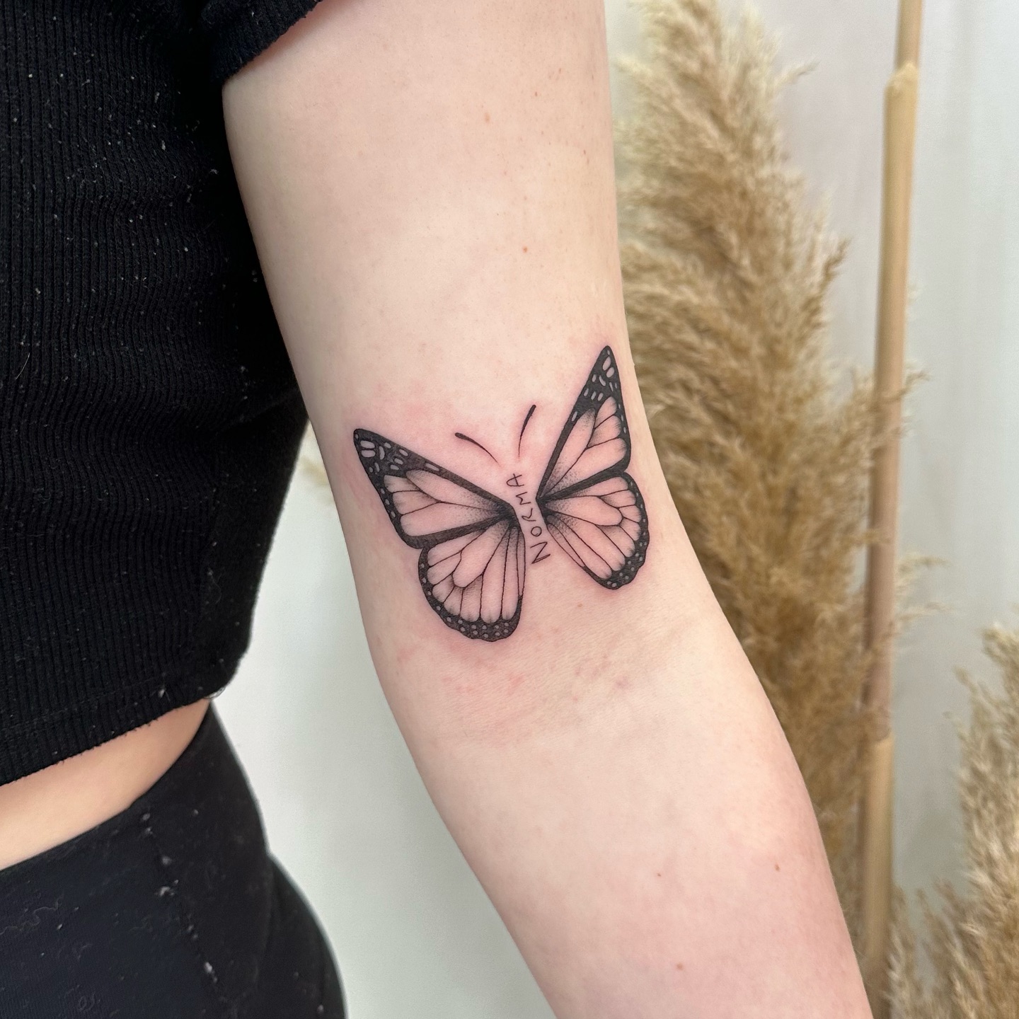 Butterfly With Name Bicep Tattoo
