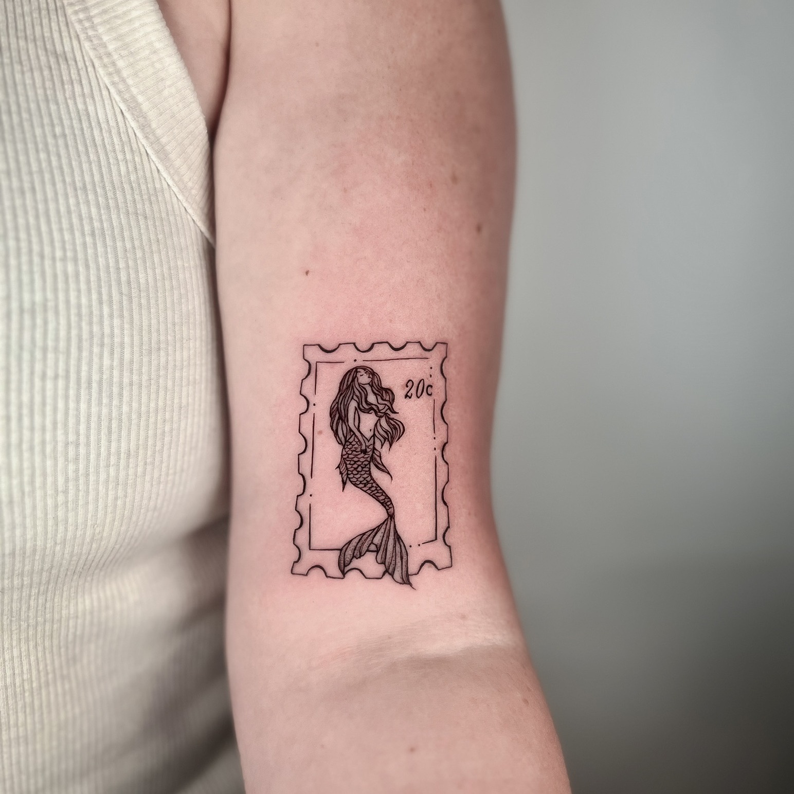 Mermaid Postage Stamp Bicep Tattoo