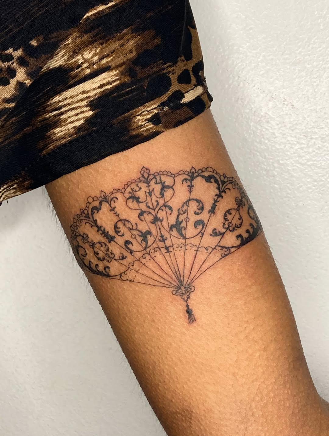 Ornate Lace Hand Fan Bicep Tattoo
