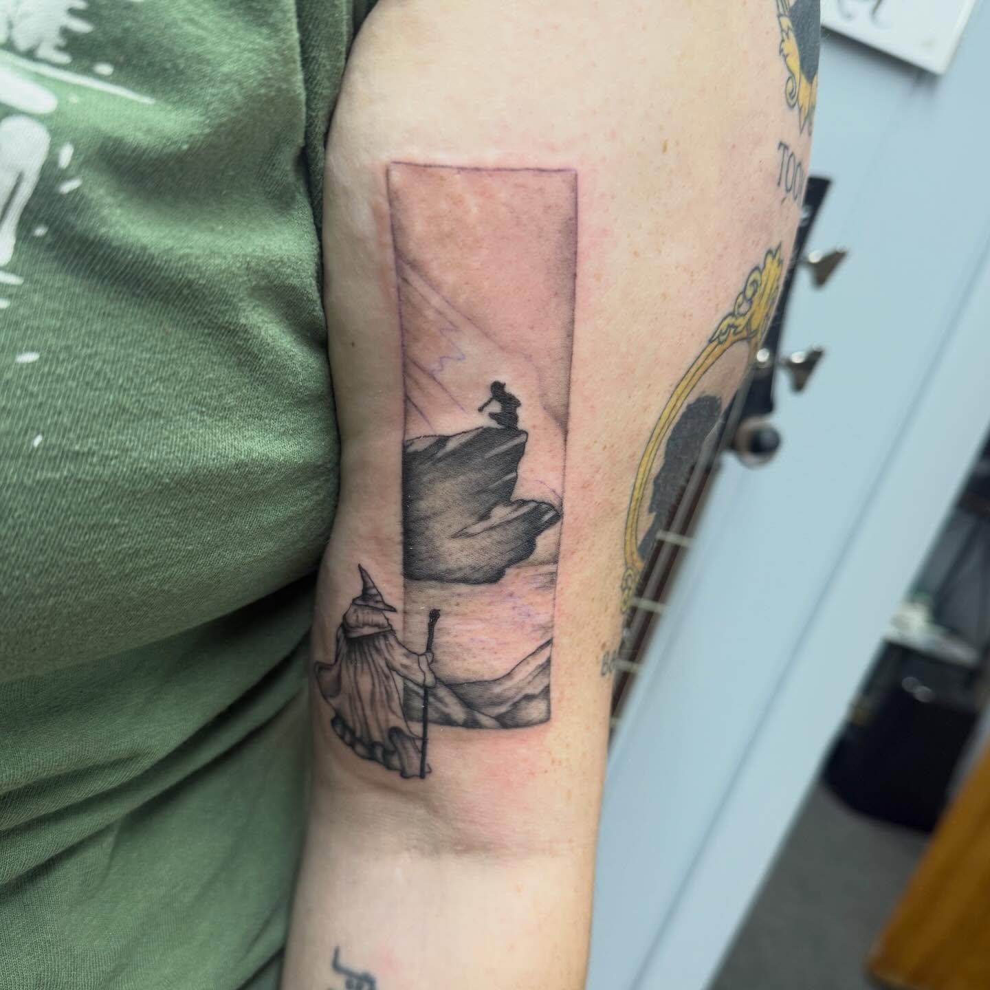 Wizard And Mountain Cliff Bicep Tattoo