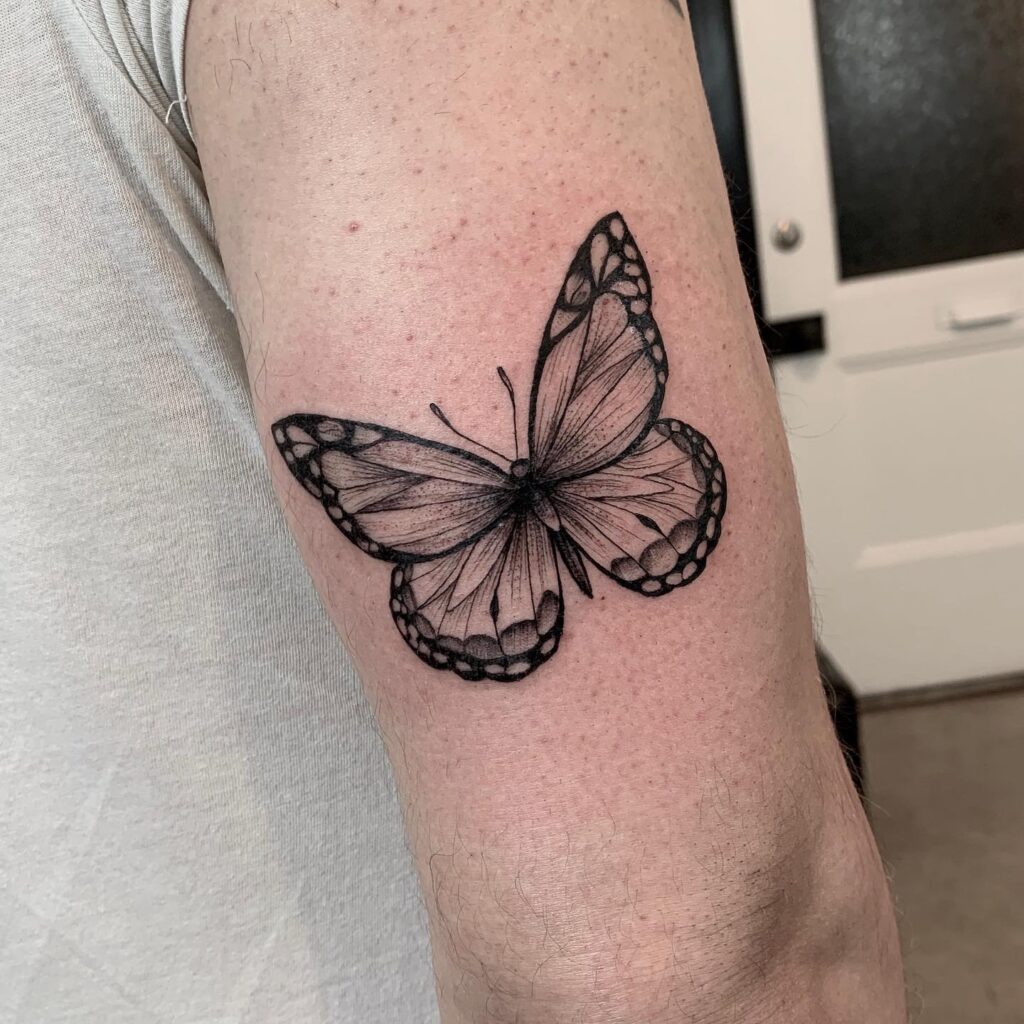 Black and grey monarch butterfly tattoo