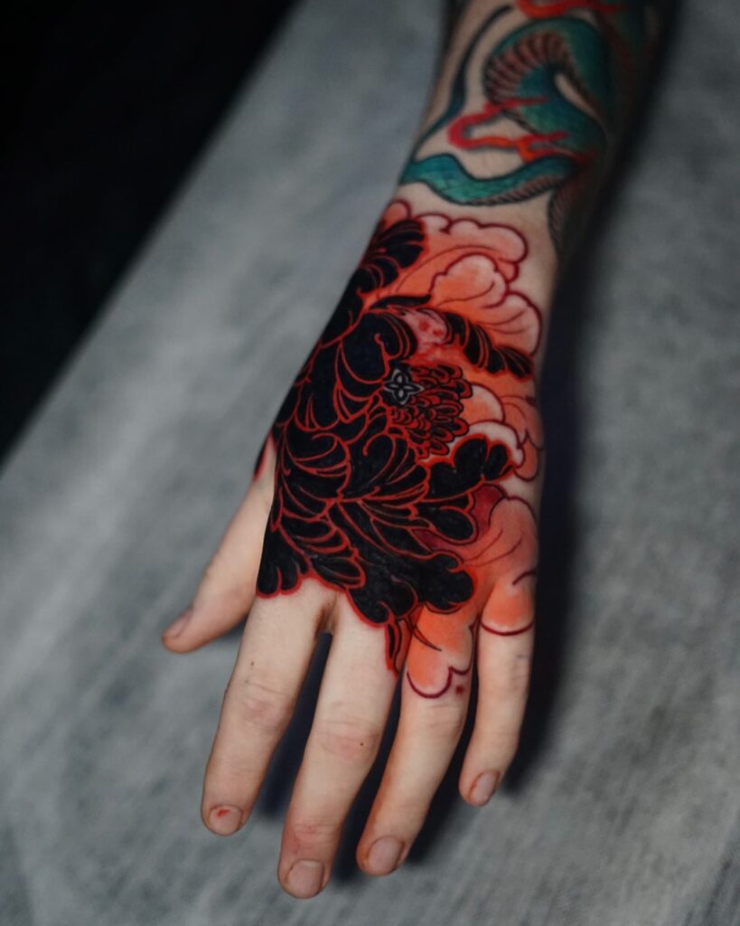 Black and Red Peony Hand Tattoo with Bold Outlines peony flower tattoo ideas tattoo