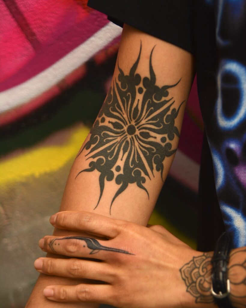 Bold Blackout Tribal Forearm Tattoo