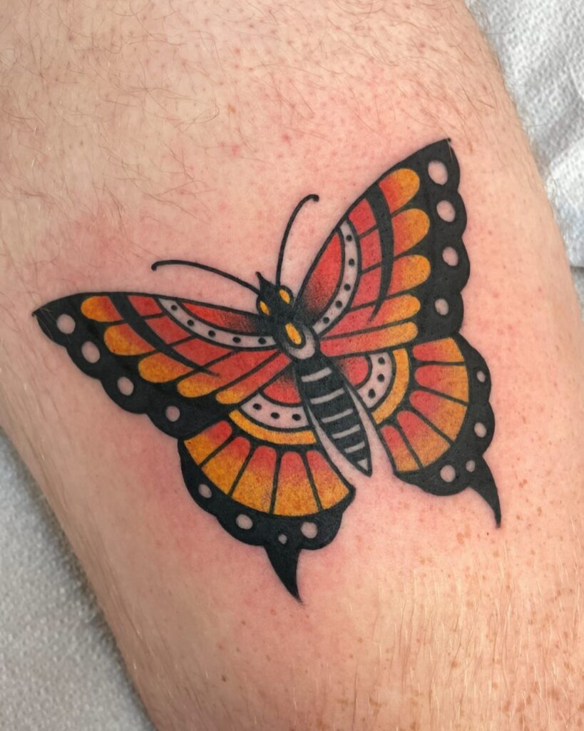 Fine line monarch butterfly tattoo on forearm