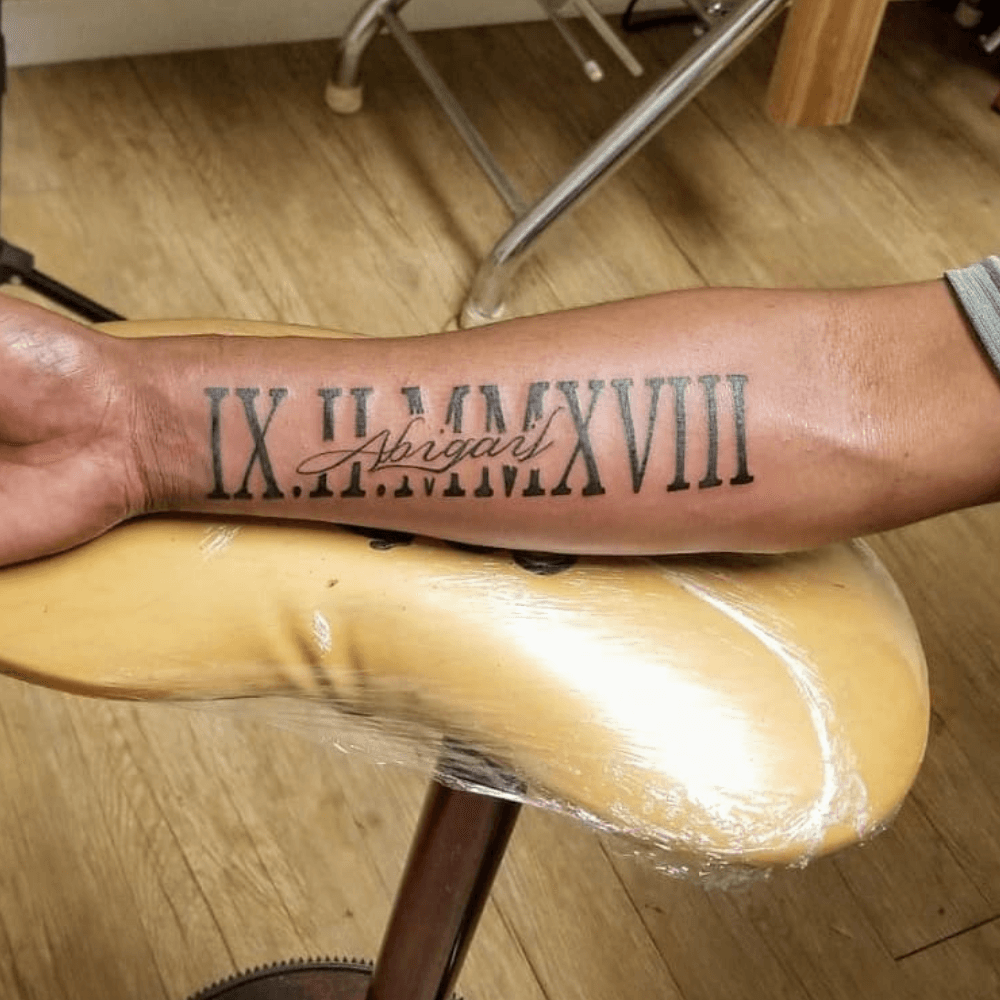 Bold Architectural Roman Numeral Birth Year kids name tattoo