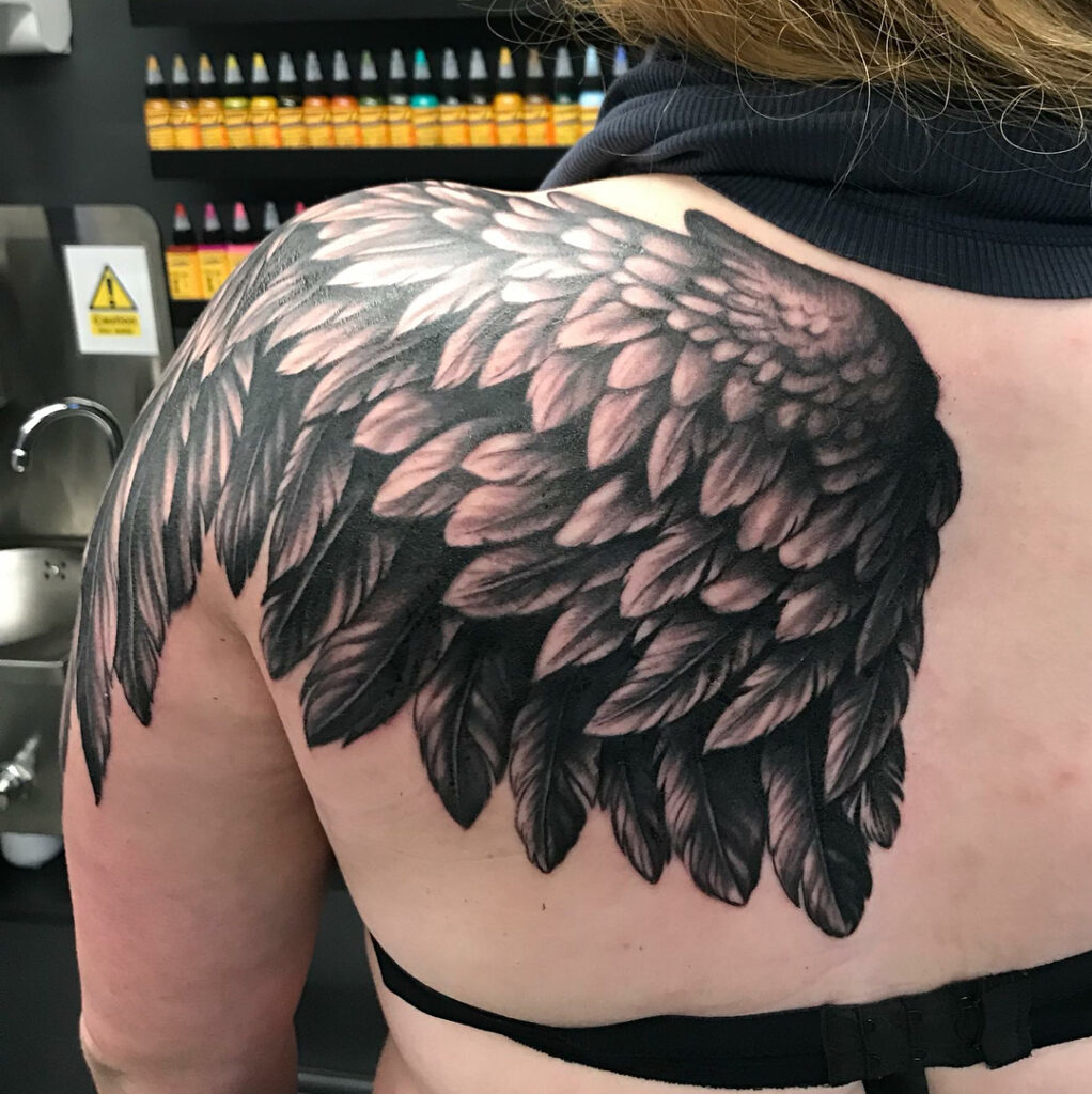 Bold Black and Gray Angel Wing Shoulder Tattoo angel wings tattoo ideas tattoo