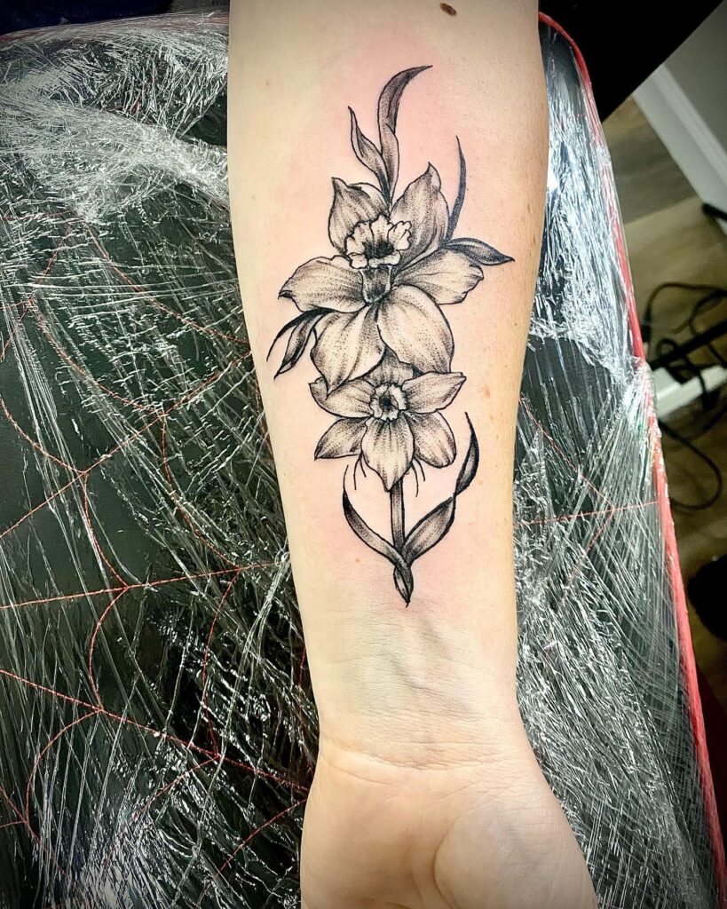 Bold Black and Grey Narcissus Forearm Tattoo december birth flower tattoo ideas tattoo