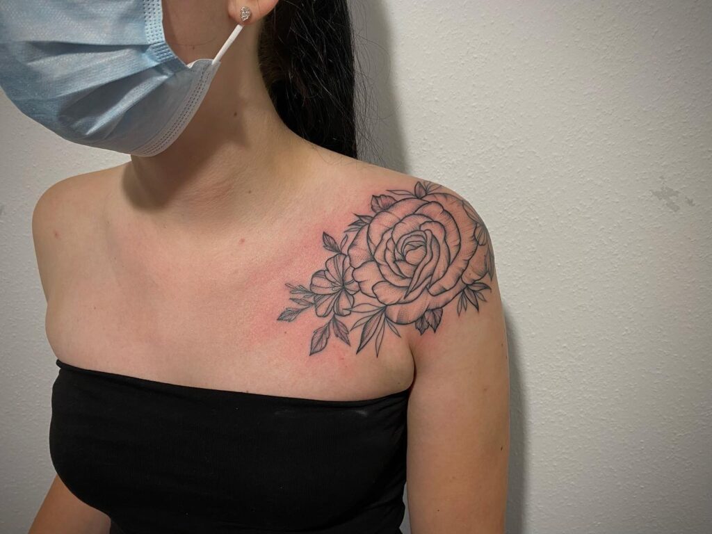 Bold Black Rose and Blossoms Shoulder Tattoo women shoulder flower tattoo ideas tattoo