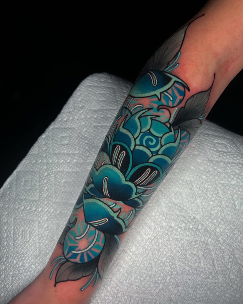 Bold Blue Peony Tattoo with Geometric Accents peony flower tattoo ideas tattoo