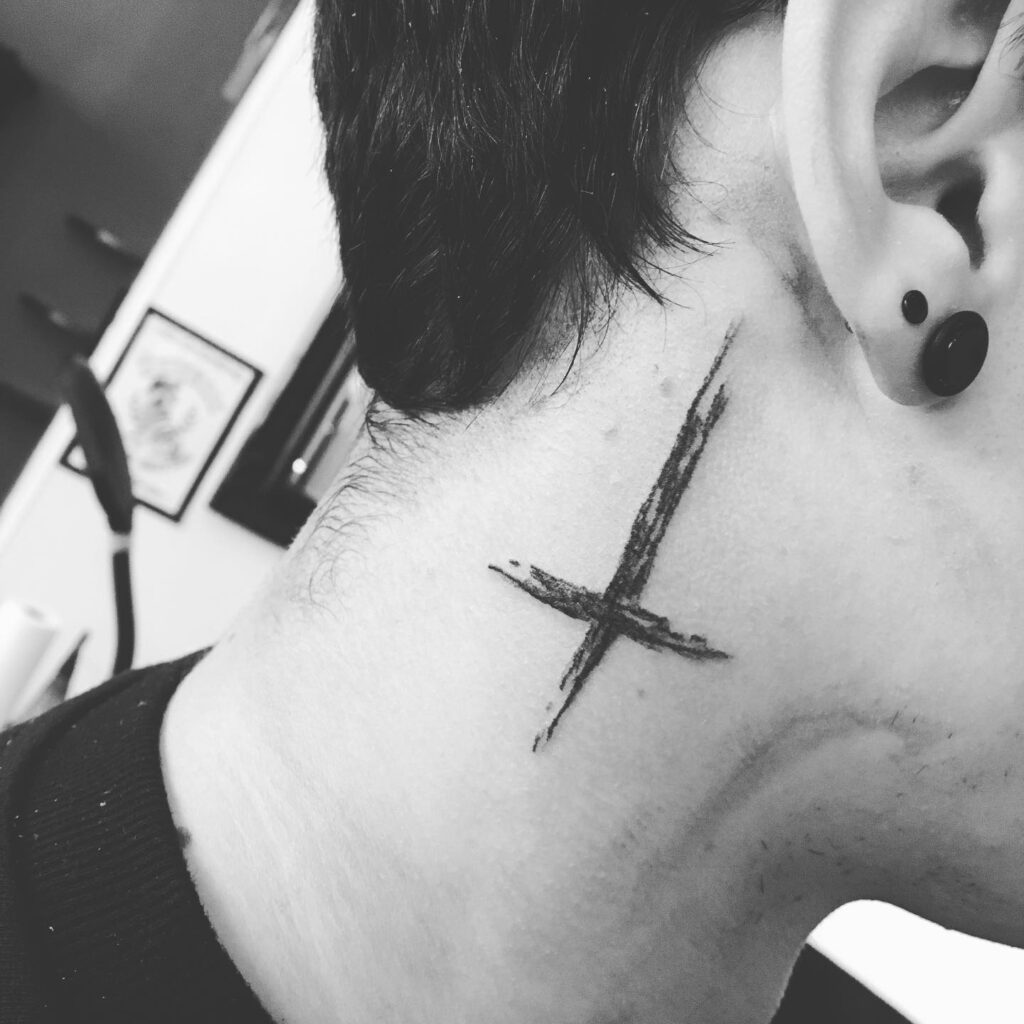 Bold brushstroke cross behind the ear