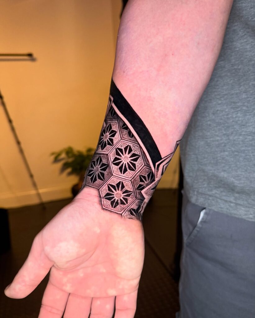Bold Geometric Mandala Wrist Tattoo with Dot-Work Shading mandala wrist tattoo ideas tattoo