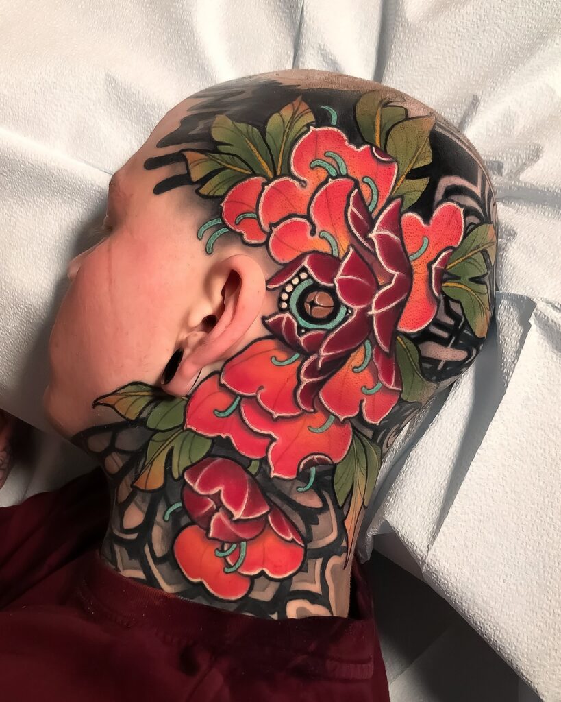 Bold Red Peony Head Tattoo with Green Leaf Accents peony flower tattoo ideas tattoo