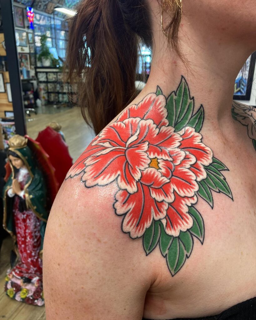 Bold Red Peony Shoulder Tattoo with Green Leaves peony flower tattoo ideas tattoo