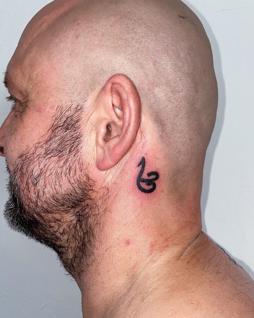 Vertical “Warrior” Script Behind the Ear behind the ear tattoo ideas for men tattoo