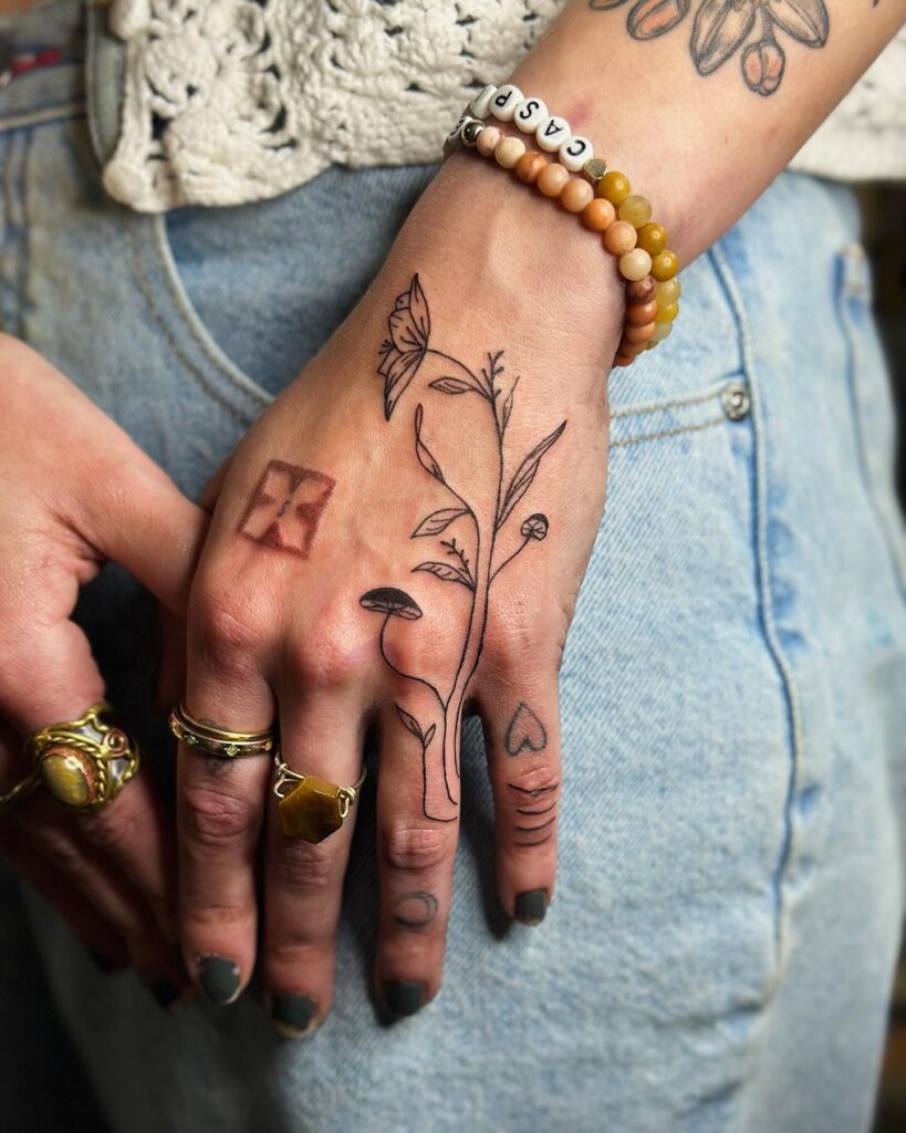 Delicate Floral Wrist And Hand Tattoo