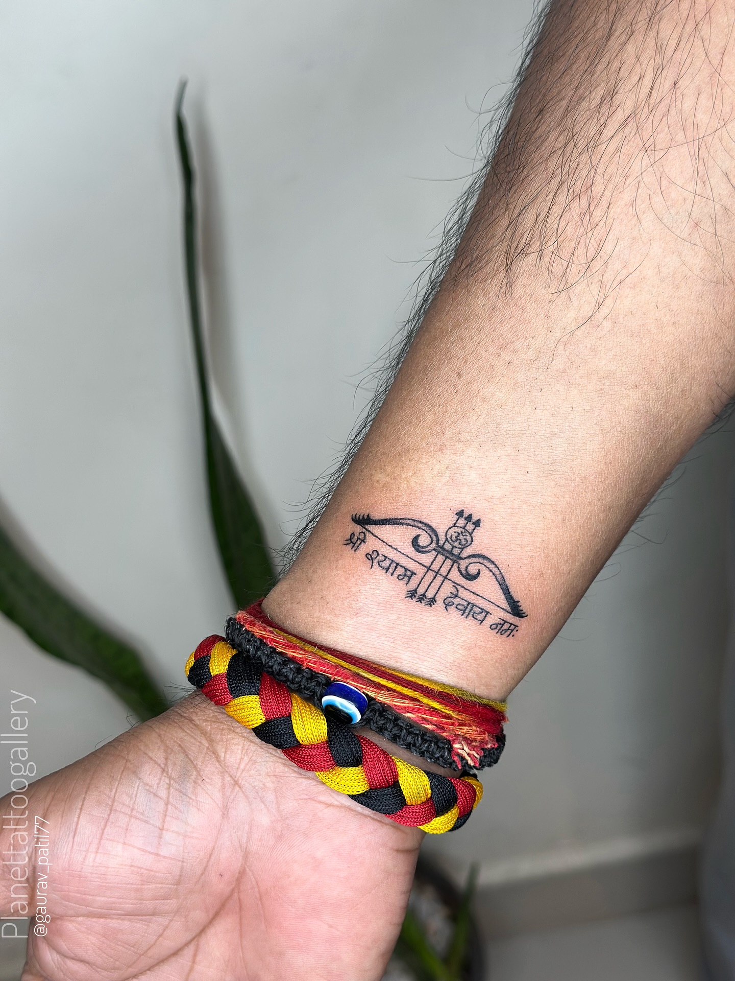 Bow and Arrow Script Wrist Tattoo
