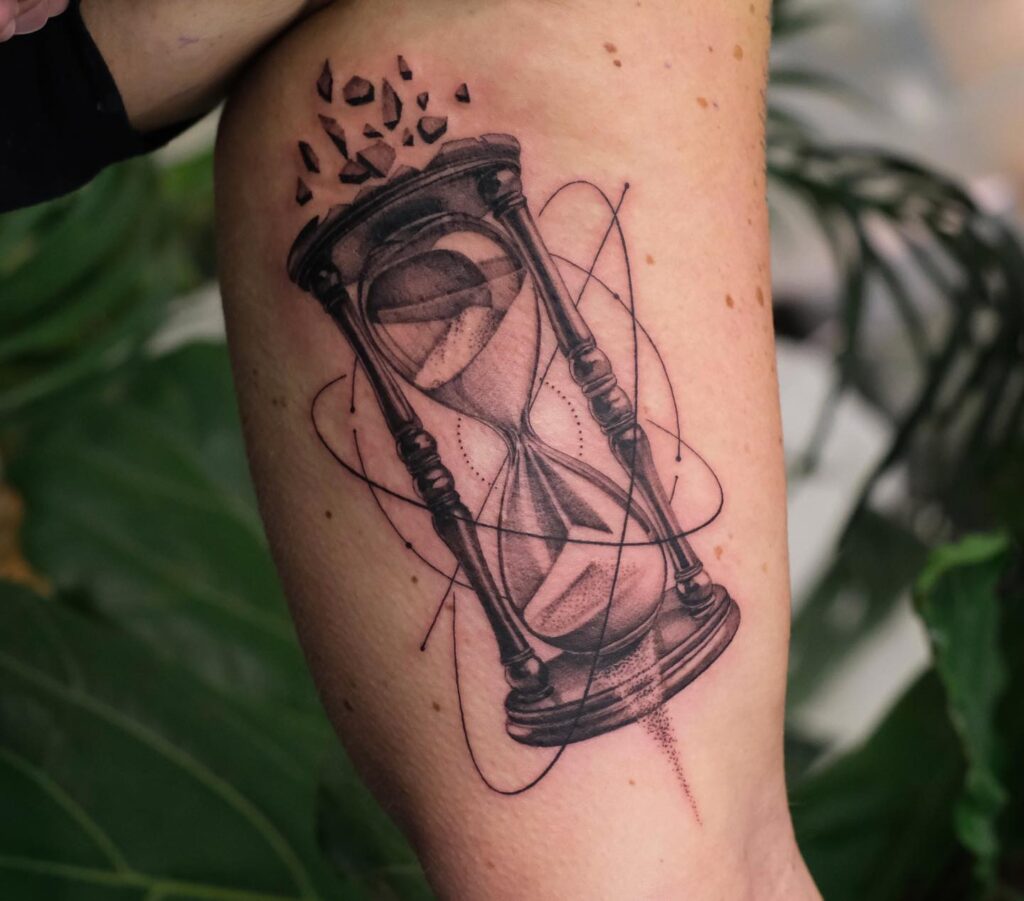 Breaking Time Hourglass Bicep Tattoo hourglass tattoo ideas tattoo