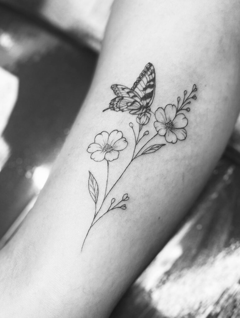 Butterfly and Wildflower Harmony fine line tattoo