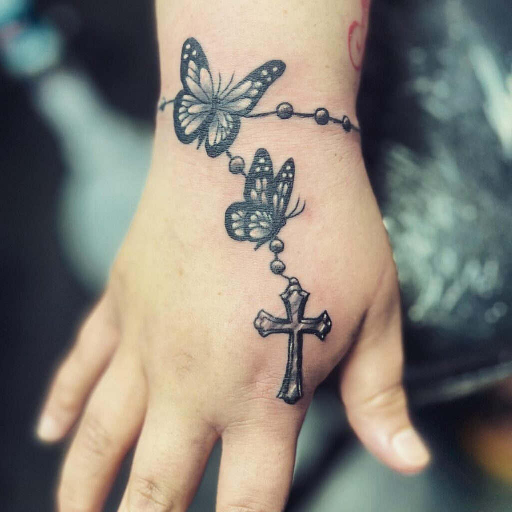 Bold Rosary Chest Tattoo With Ornamental Cross
