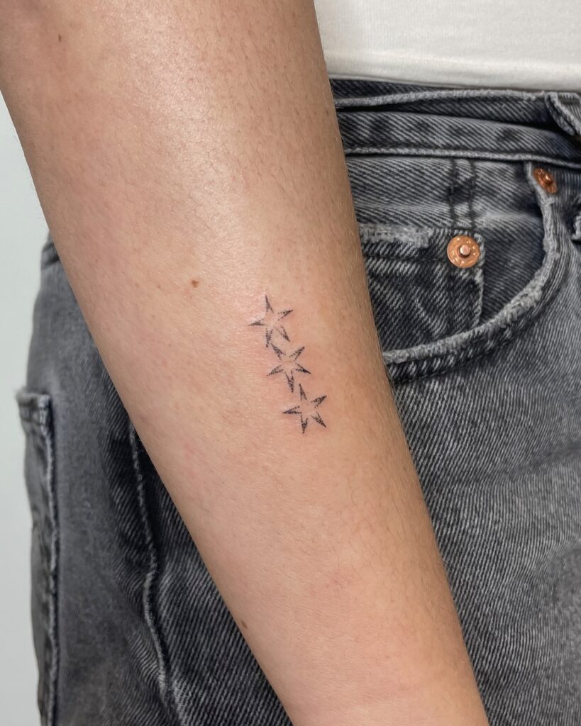 Cascading Star Forearm Tattoo