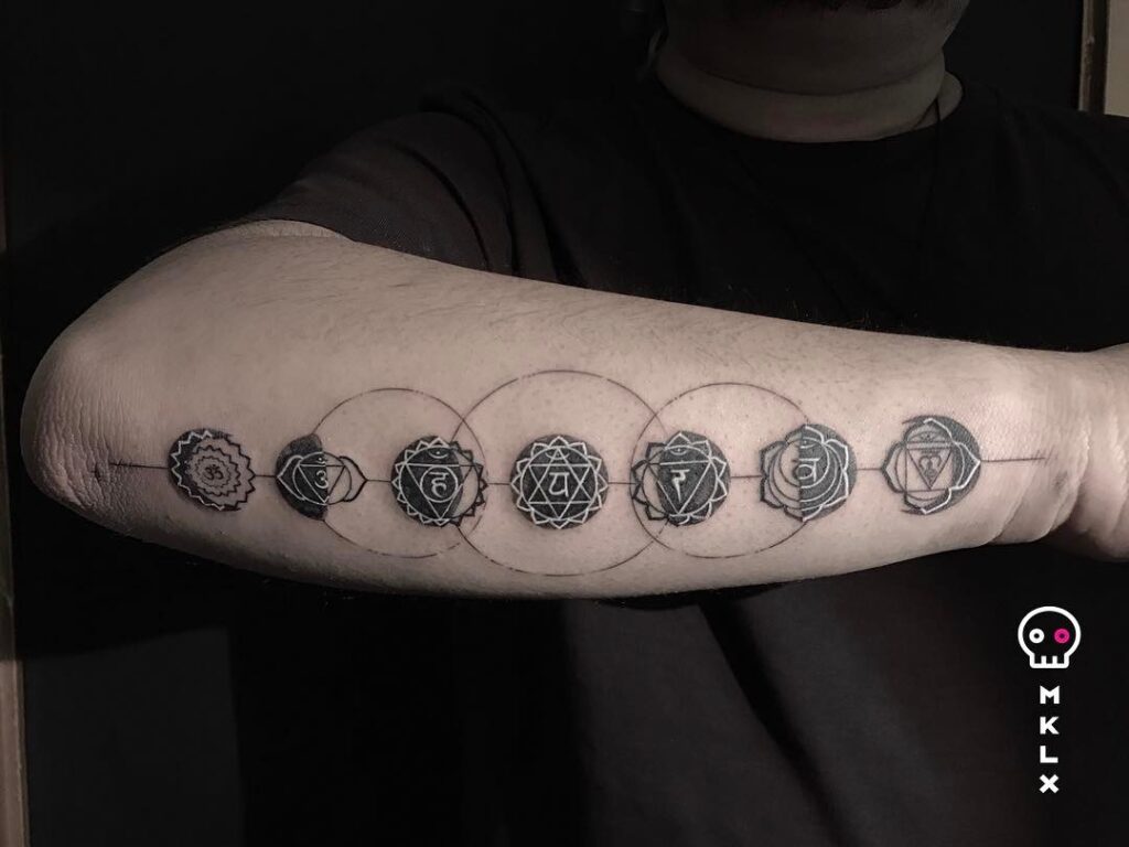 Moon phases with chakras arm tattoo