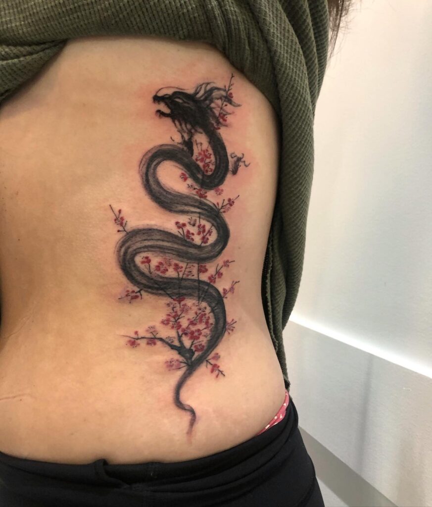 Cherry Blossoms and Black Dragon Rib Tattoo cherry blossom tattoo ideas tattoo