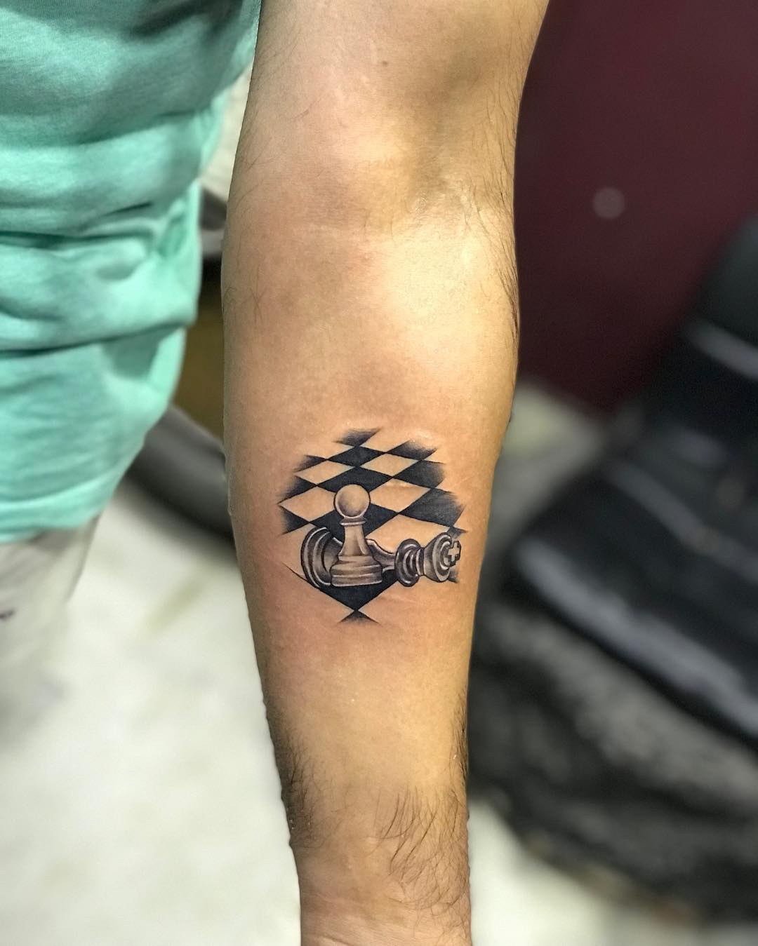 Chess Pieces and Checkerboard Forearm Tattoo