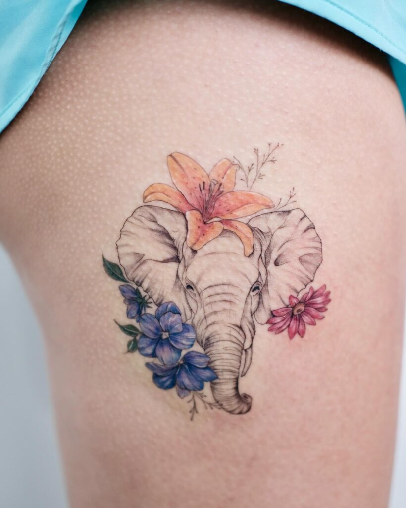 Colorful elephant tattoo with mixed flowers