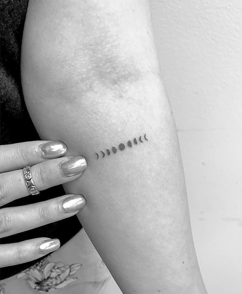 Small horizontal moon phases tattoo
