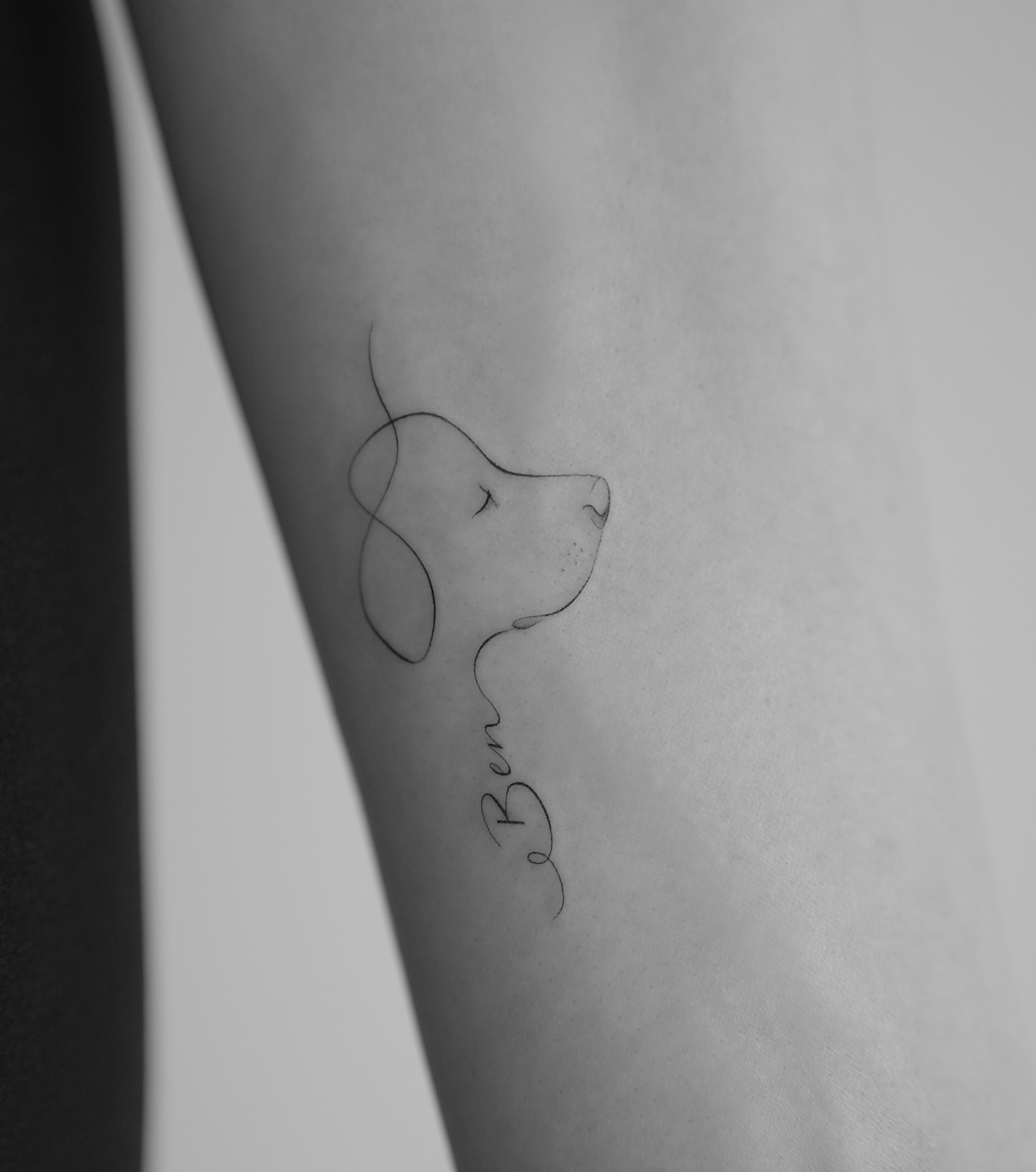 One line dog portrait tattoo with name