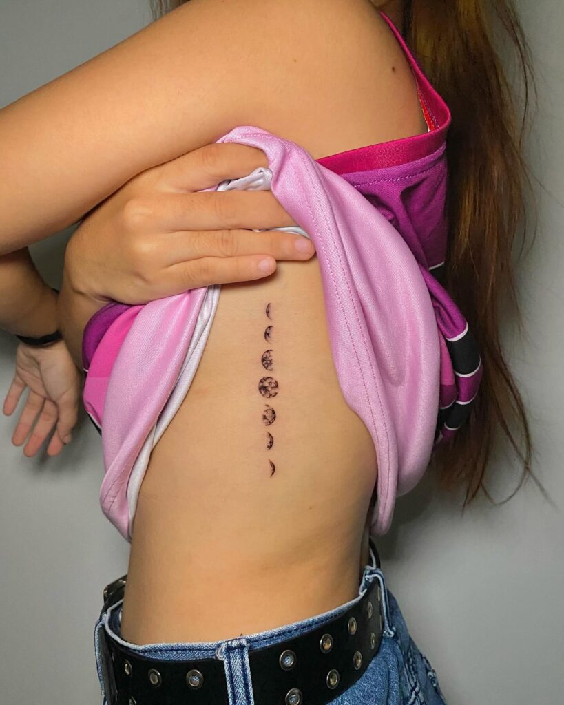 Side rib moon phases tattoo