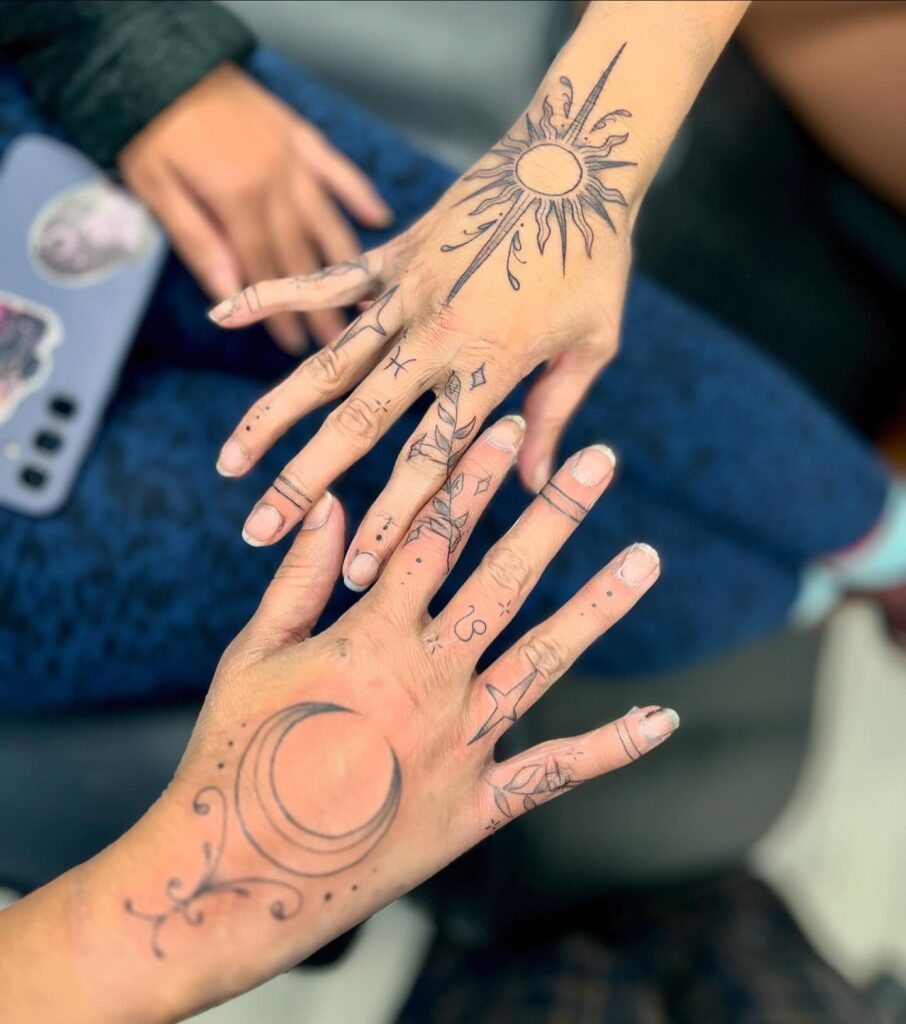 Cosmic hands holding sun and moon tattoos