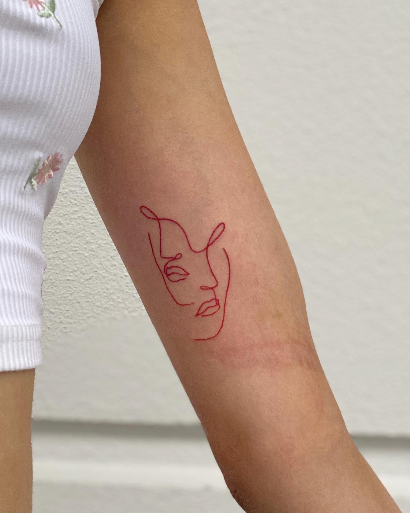One line red ink couple face tattoo