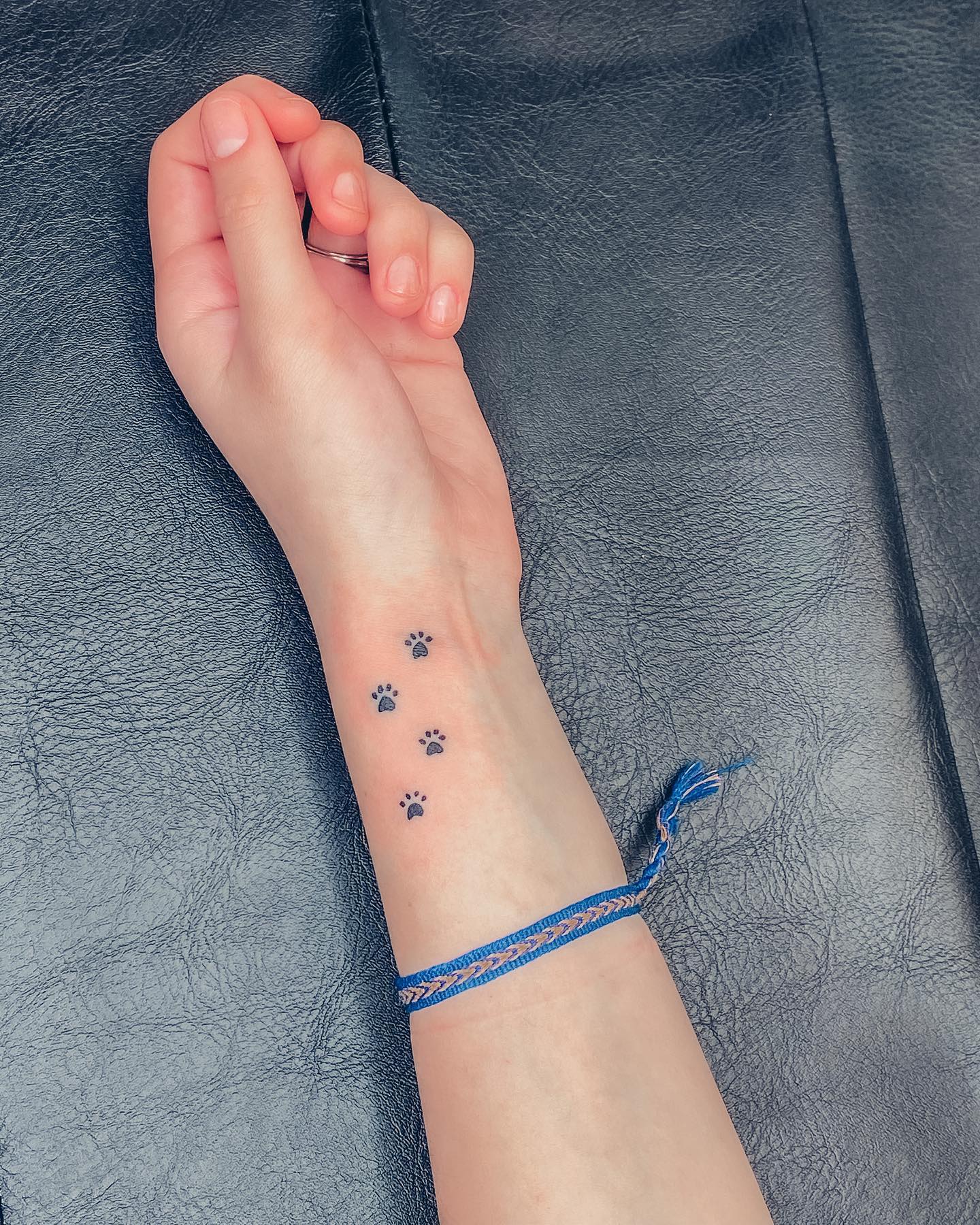 Tiny Paw Print Trail Tattoo