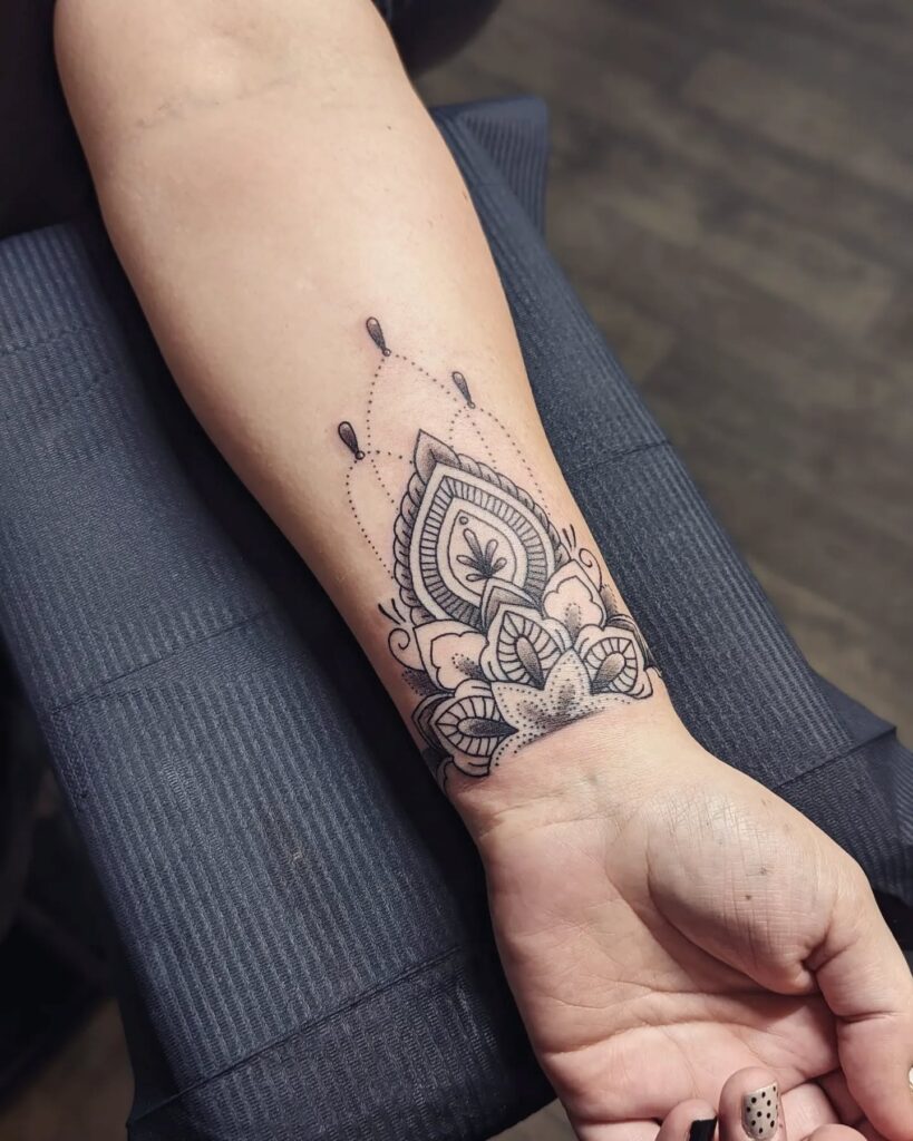 Decorative Mandala Wrist Tattoo with Dotwork Accents mandala wrist tattoo ideas tattoo