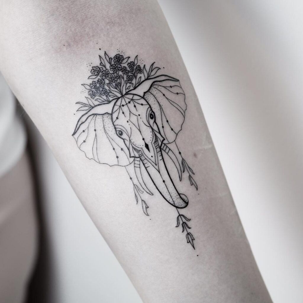 Delicate elephant tattoo with floral crown