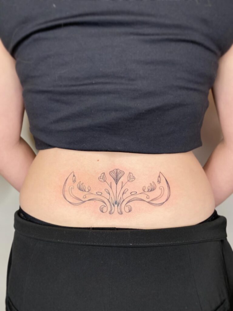 Minimalist Bat Lower Back Tattoo