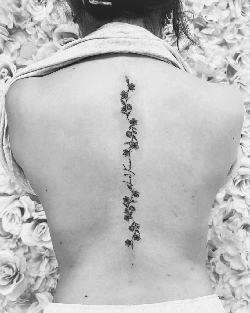 Regal Moon And Symbolic Spine Tattoo