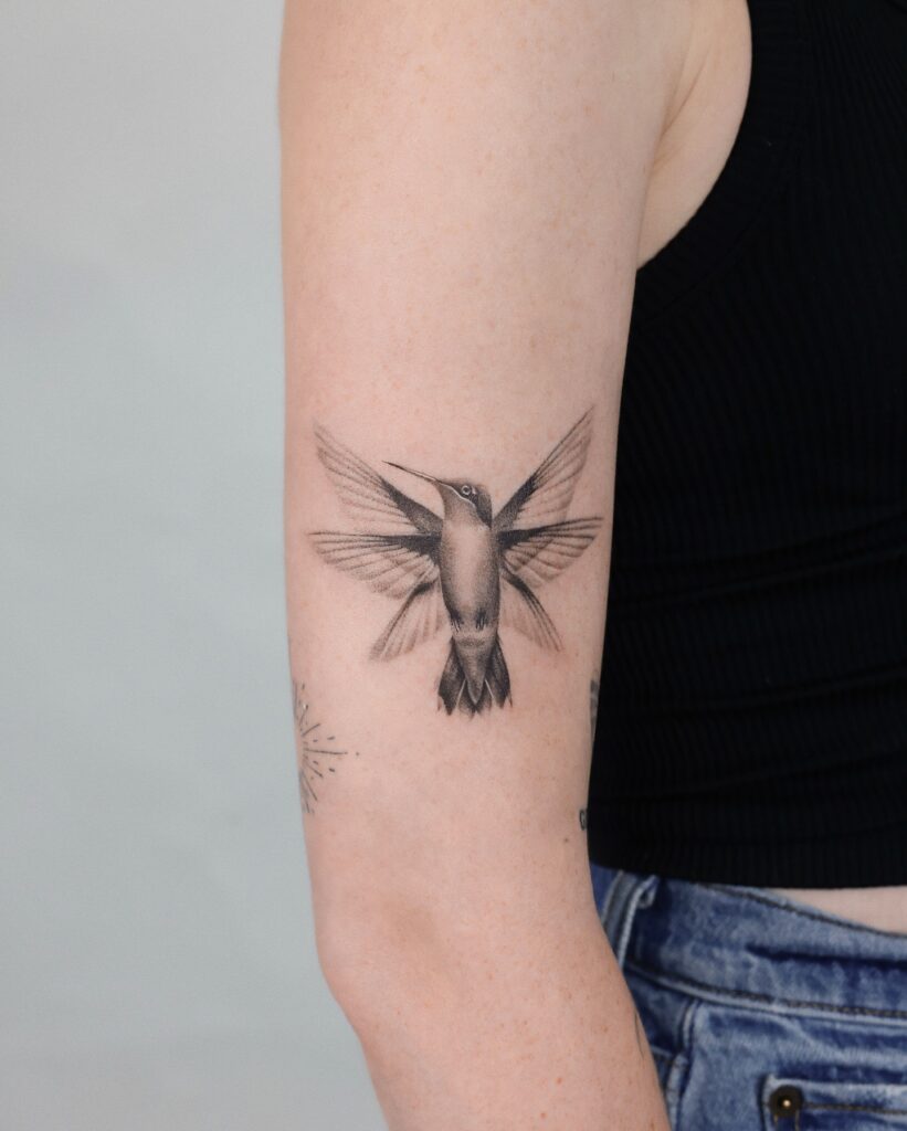 Delicate Hummingbird in Flight Tattoo bird tattoo ideas for women with meaning tattoo