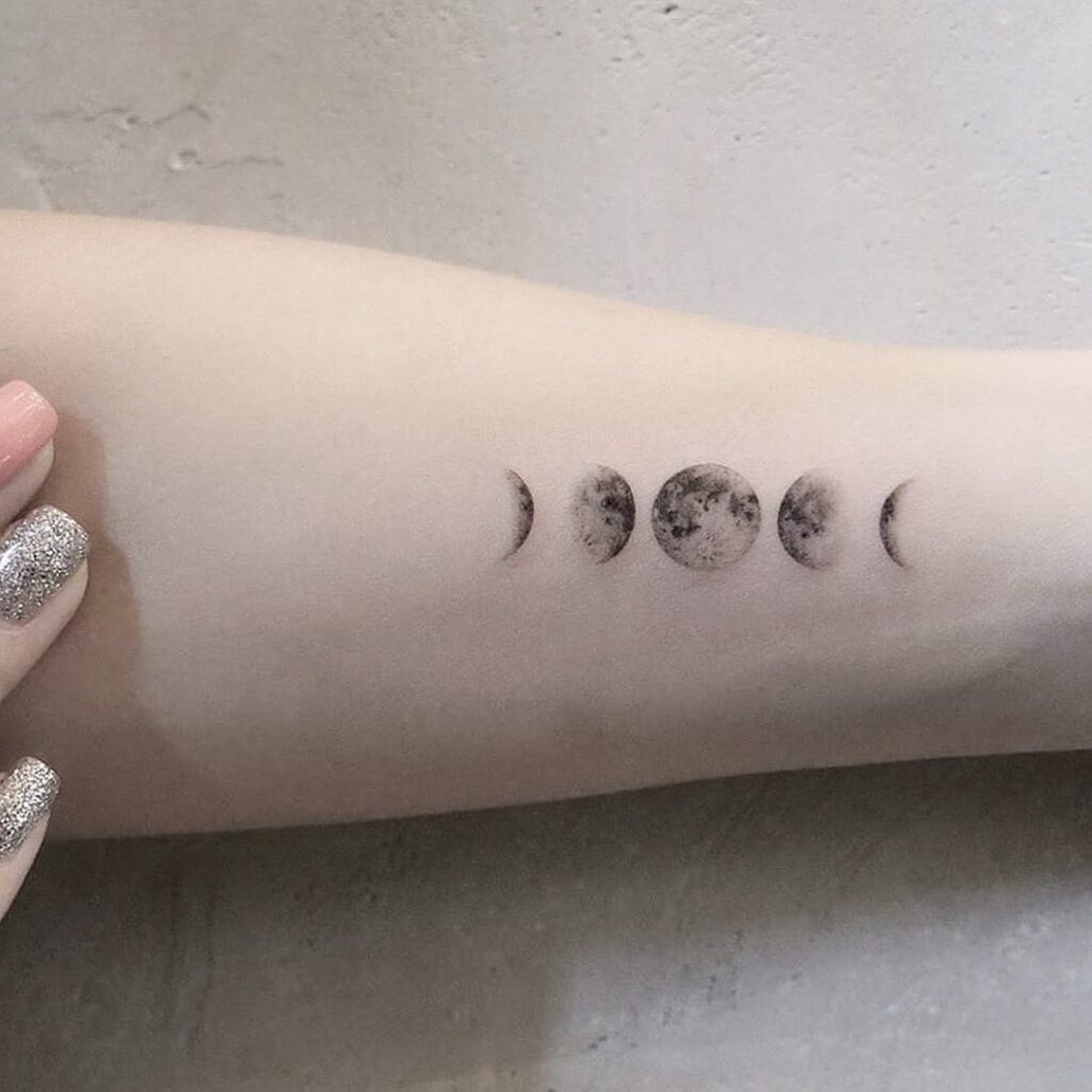 Delicate inner arm moon phases tattoo